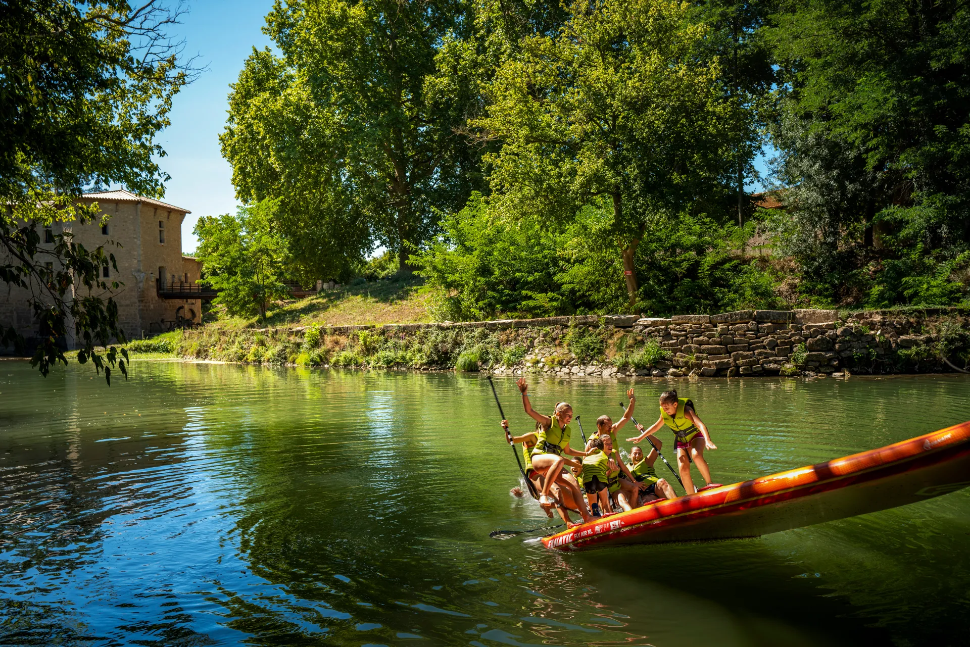 une famille s'amuse sur un paddle géant sur l'Hérault